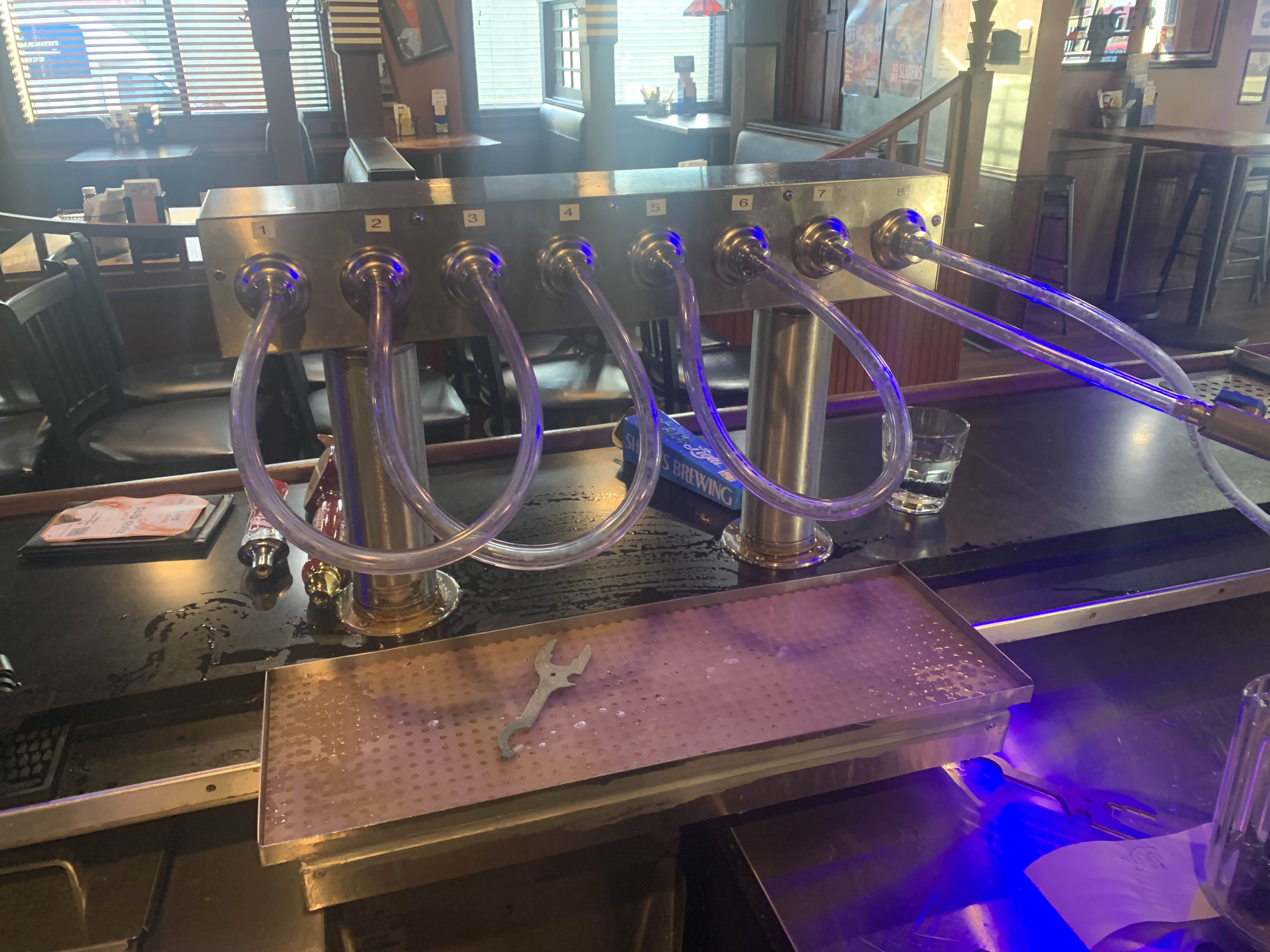 Close-up of the draft cleaning rig showing pressure gauge, shutoff valve, and illuminated control switch.